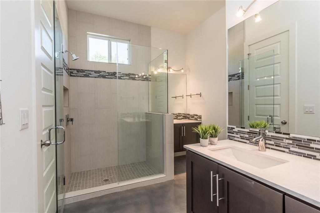 1403 Arcadia Avenue, Unit A Austin, TX 78757 - Photo 27 of 35 a bathroom with a shower sink and mirror