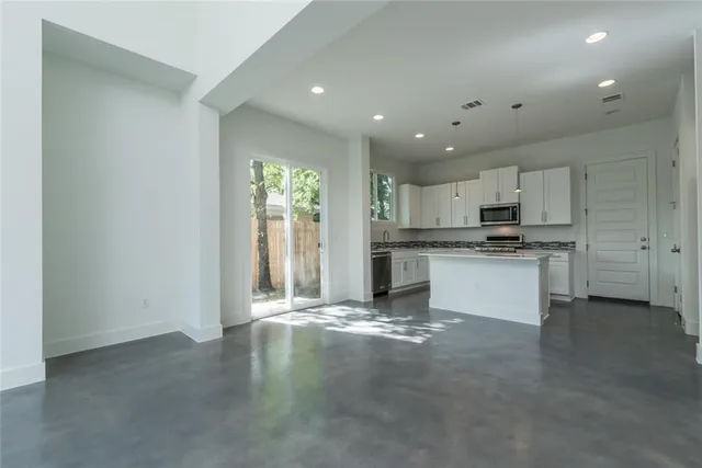 a view of a kitchen with a sink and dishwasher a refrigerator with wooden floor