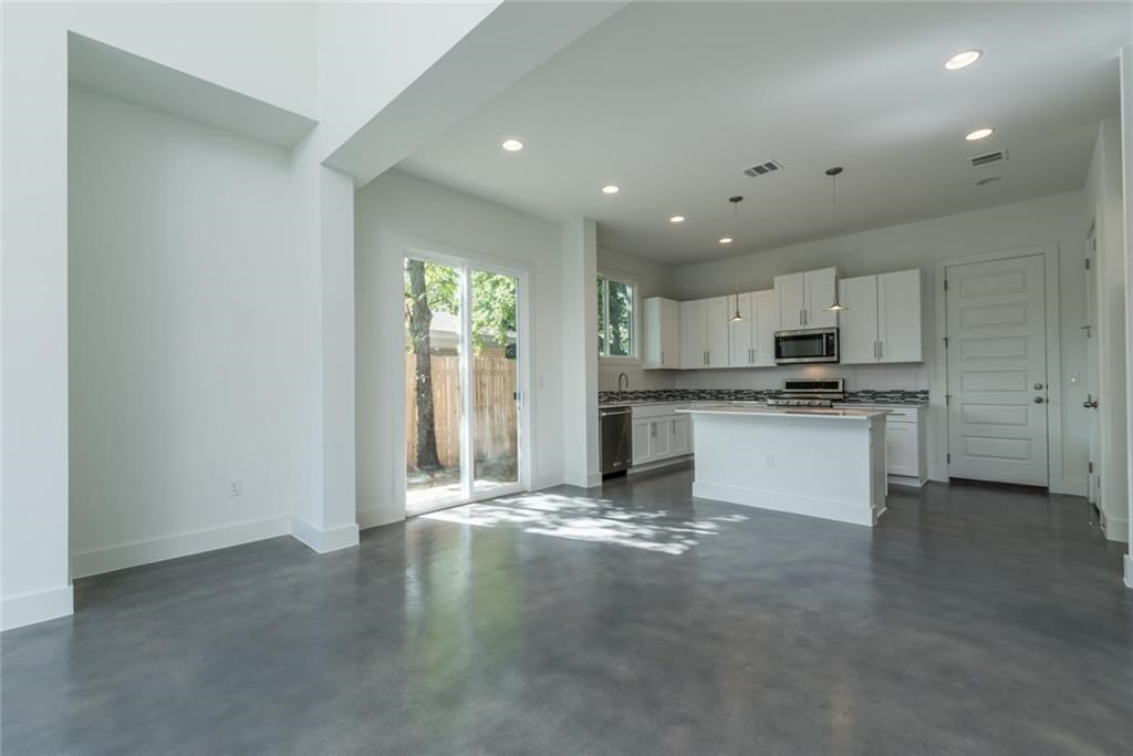 1403 Arcadia Avenue, Unit A Austin, TX 78757 - Photo 4 of 35 a view of a kitchen with a sink and dishwasher a refrigerator with wooden floor