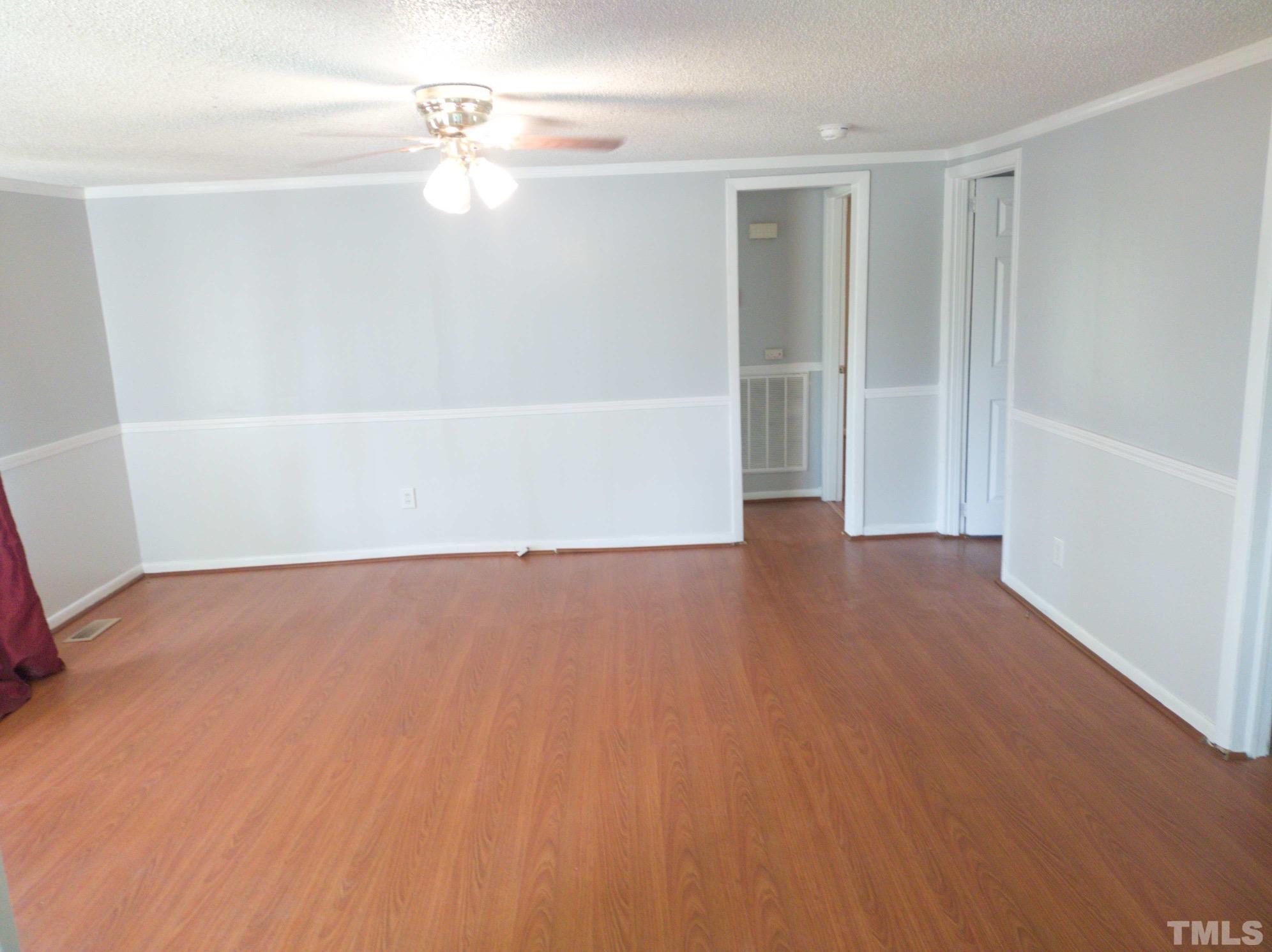 563 Williams Road Spring Hope, NC 27882 - Photo 11 of 16 an empty room with wooden floor ceiling fan and window