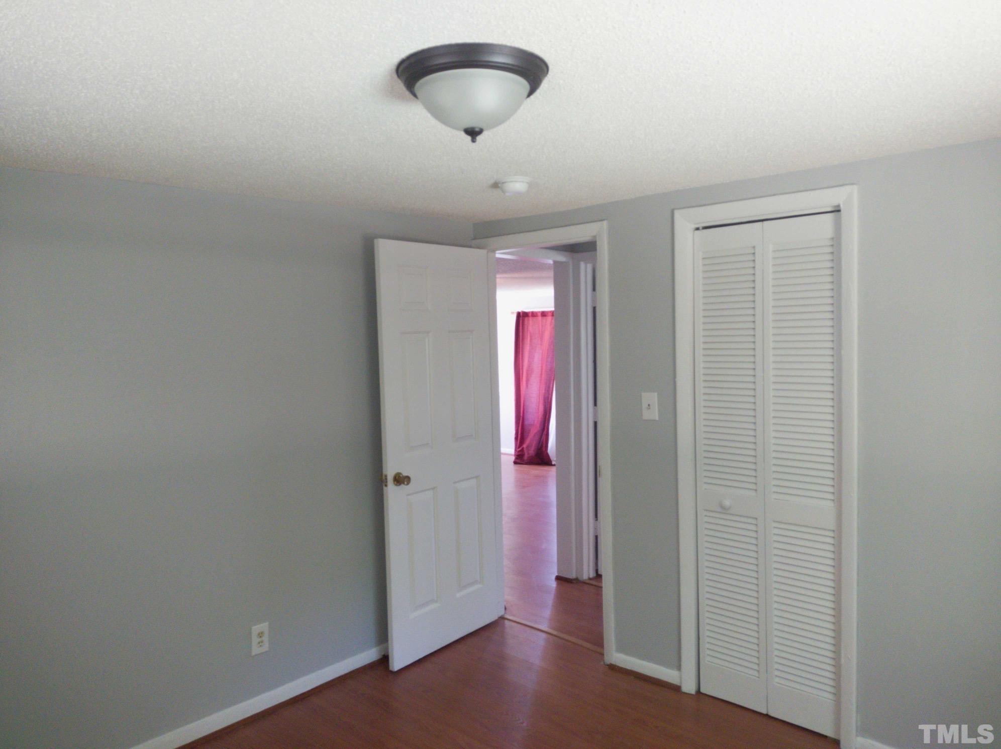 563 Williams Road Spring Hope, NC 27882 - Photo 10 of 16 an empty room with wooden floor and windows