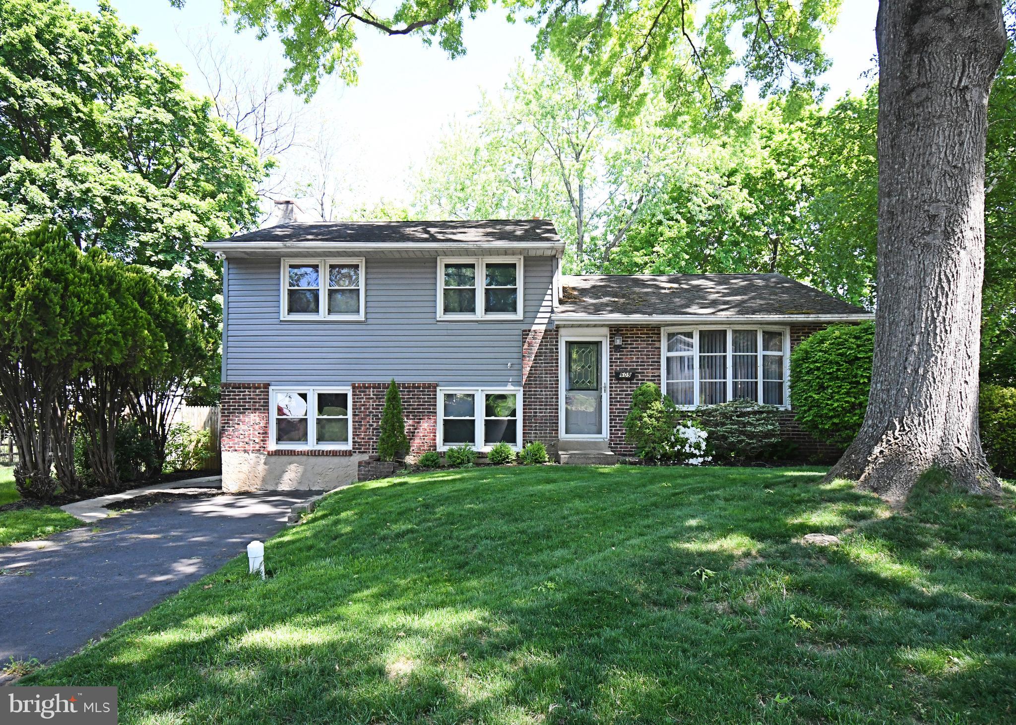 609 Mansfield Road Willow Grove, PA 19090 - Photo 2 of 68 a view of a yard in front of a house with a large tree