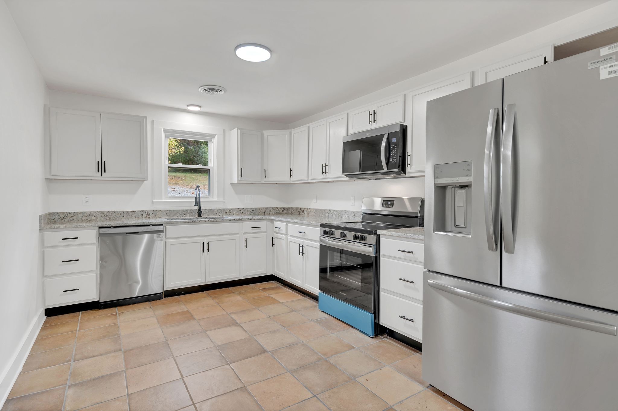 5060 Drakes Branch Road Nashville, TN 37218 - Photo 12 of 43 a kitchen with white cabinets and stainless steel appliances