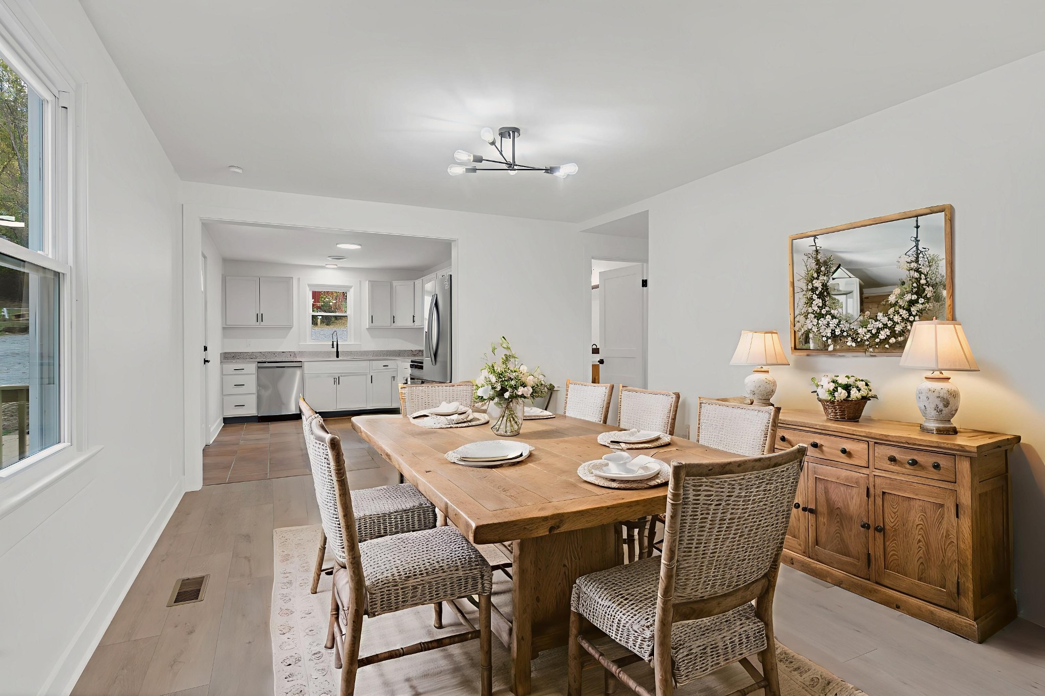 5060 Drakes Branch Road Nashville, TN 37218 - Photo 8 of 43 a view of a dining room and livingroom with furniture wooden floor a rug and a chandelier