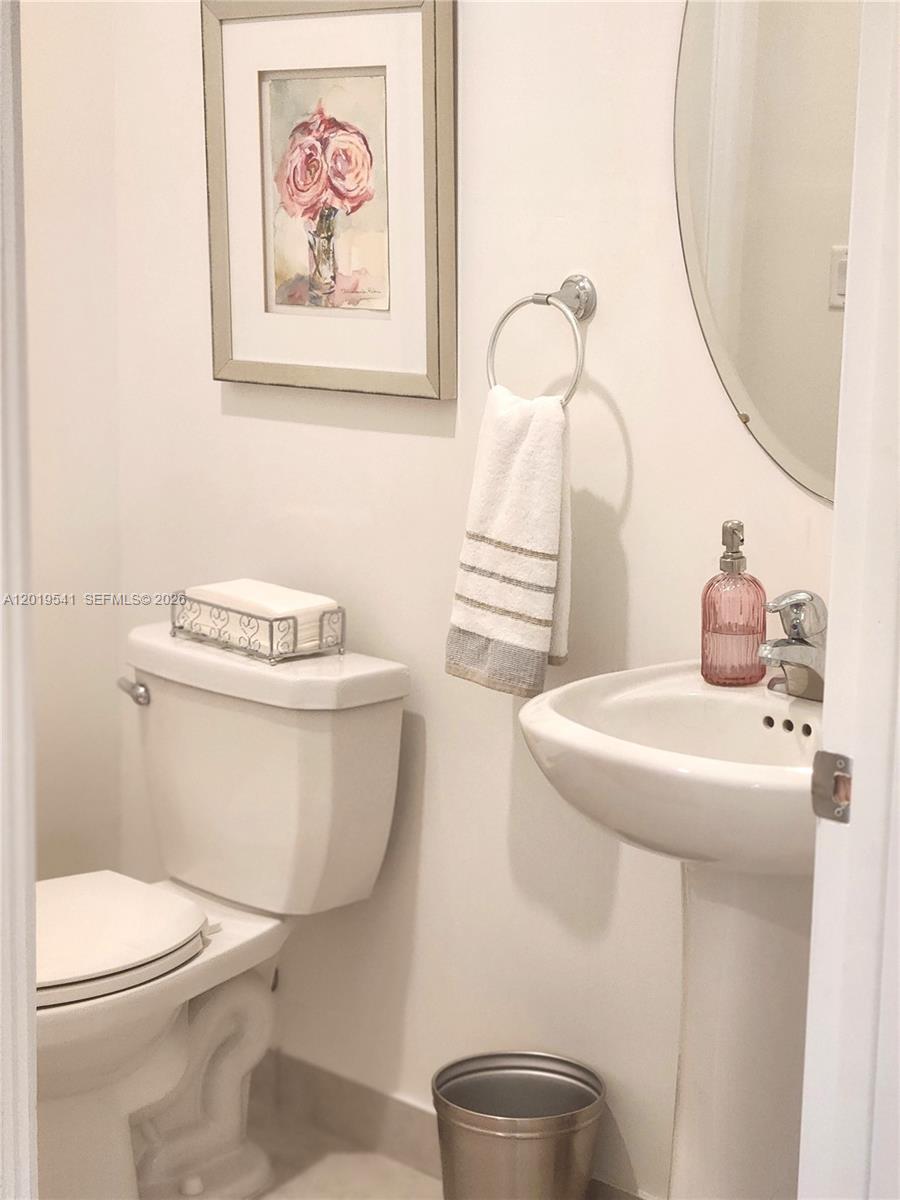 24400 Southwest 119th Place Homestead, FL 33032 - Photo 5 of 22 a bathroom with a toilet a sink and a mirror