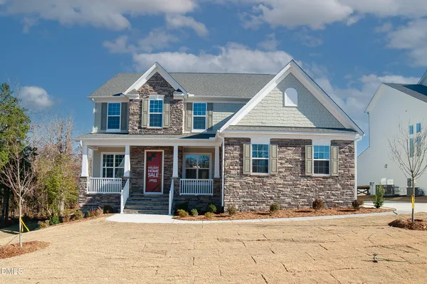 a view of a house with snow on the road
