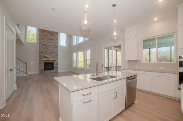 a kitchen with stainless steel appliances white cabinets and a stove