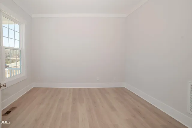 a spacious bathroom with a granite countertop sink a toilet a mirror and a bathtub