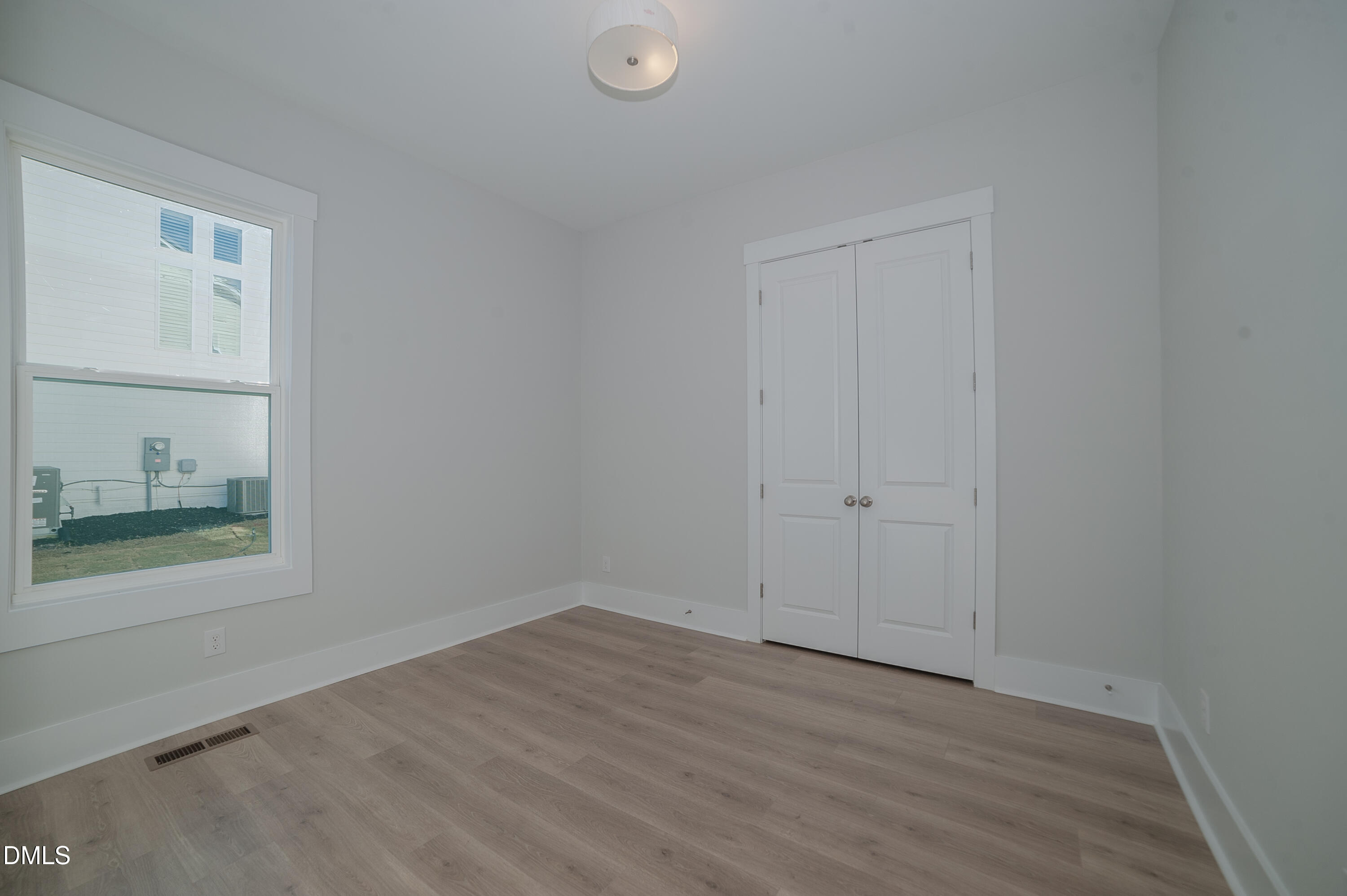 2 Wolf Tree Way Efland, NC 27243 - Photo 11 of 29 a view of an empty room with wooden floor and a window