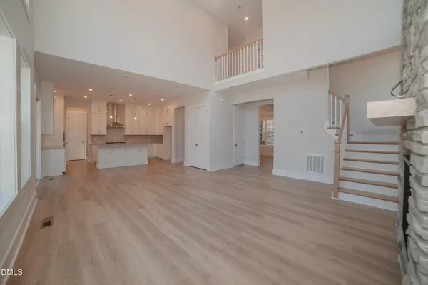 a view of a kitchen and an empty room