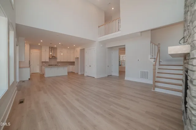 a view of a kitchen and an empty room