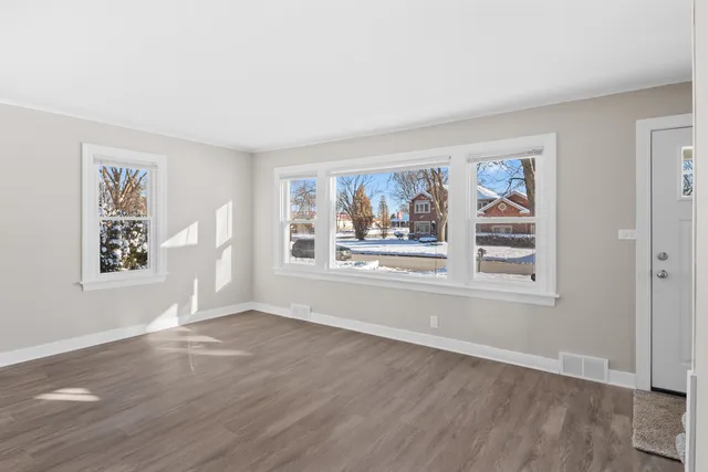 a view of wooden floor and windows in a room