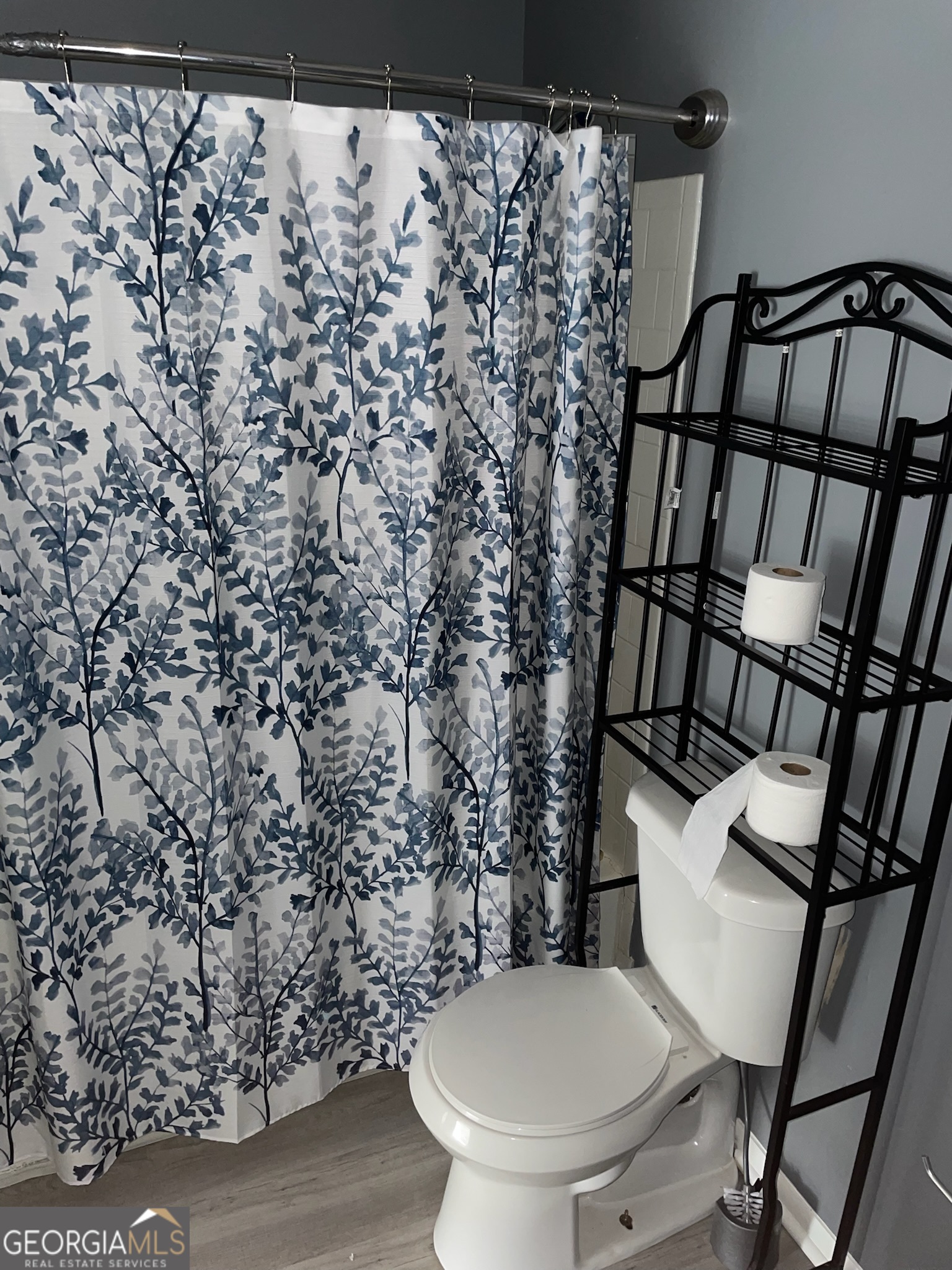 4701 Flat Shoals Road, Unit 25F Union City, GA 30291 - Photo 14 of 21 a bathroom with a toilet and a shower curtain
