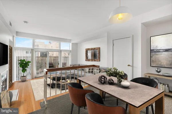 a dinning room with furniture and wooden floor