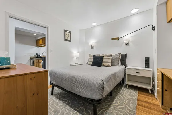 a bedroom with a bed and a table