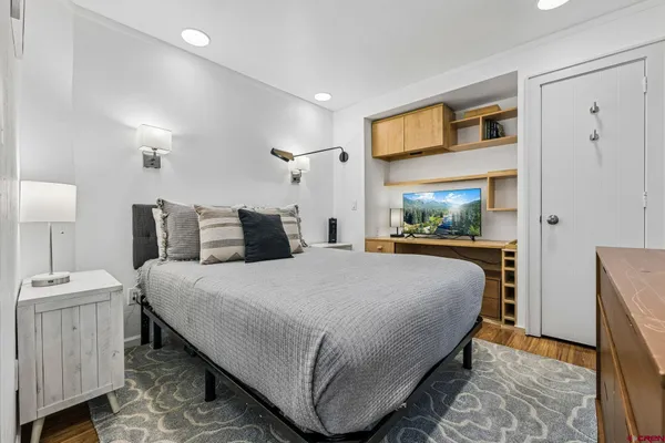 a bedroom with bed and a night stand