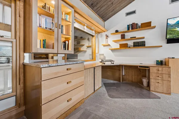 a kitchen with cabinets wooden floor and stainless steel appliances