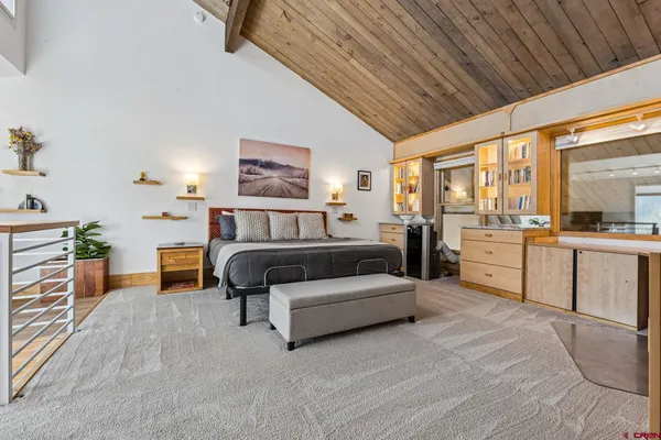 a bedroom with furniture and a large window