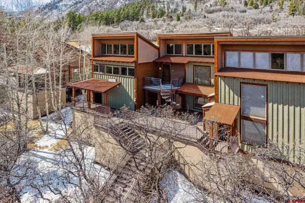 a view of a house with a yard and sitting area