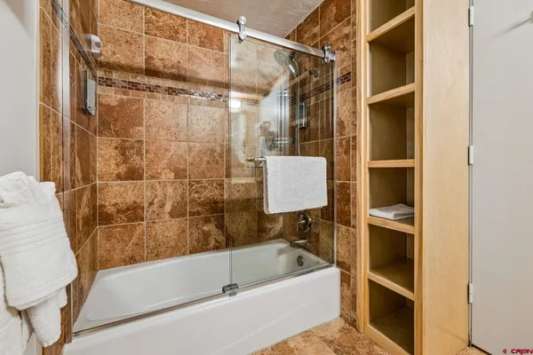 a bathroom with a tub and a shower