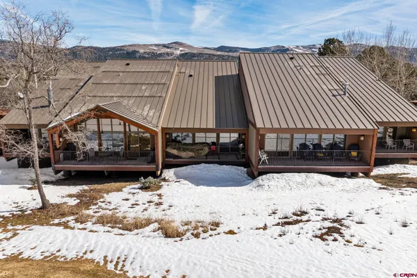 a view of a house with snow on the road