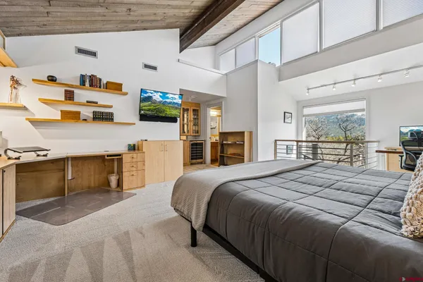 a bedroom with a bed and a television