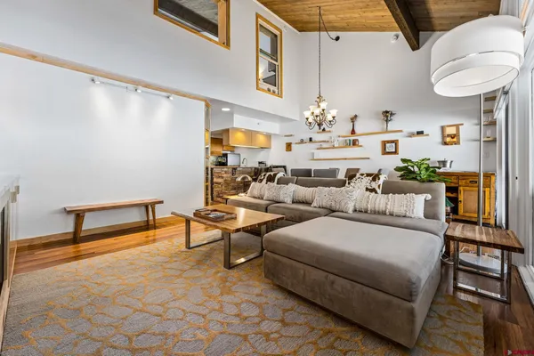 a living room with furniture and a chandelier