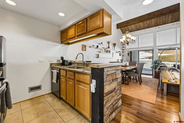 a kitchen with stainless steel appliances granite countertop a sink and cabinets