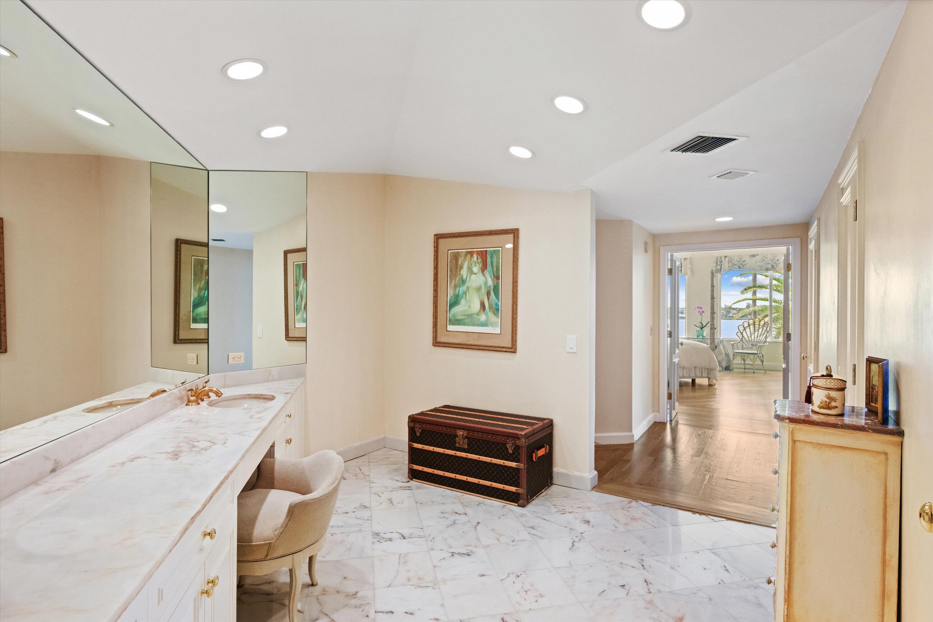 200 Bradley Place, Unit 303 Palm Beach, FL 33480 - Photo 14 of 40 a spacious bedroom with a bed a couch and a view of en suite bathroom