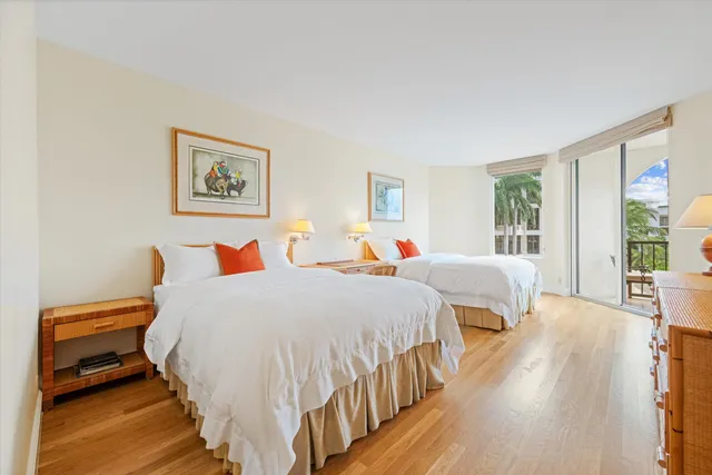 a bedroom with bed and wooden floor