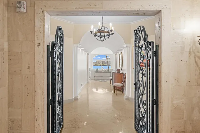 a view of a hallway with dining room and wooden floor