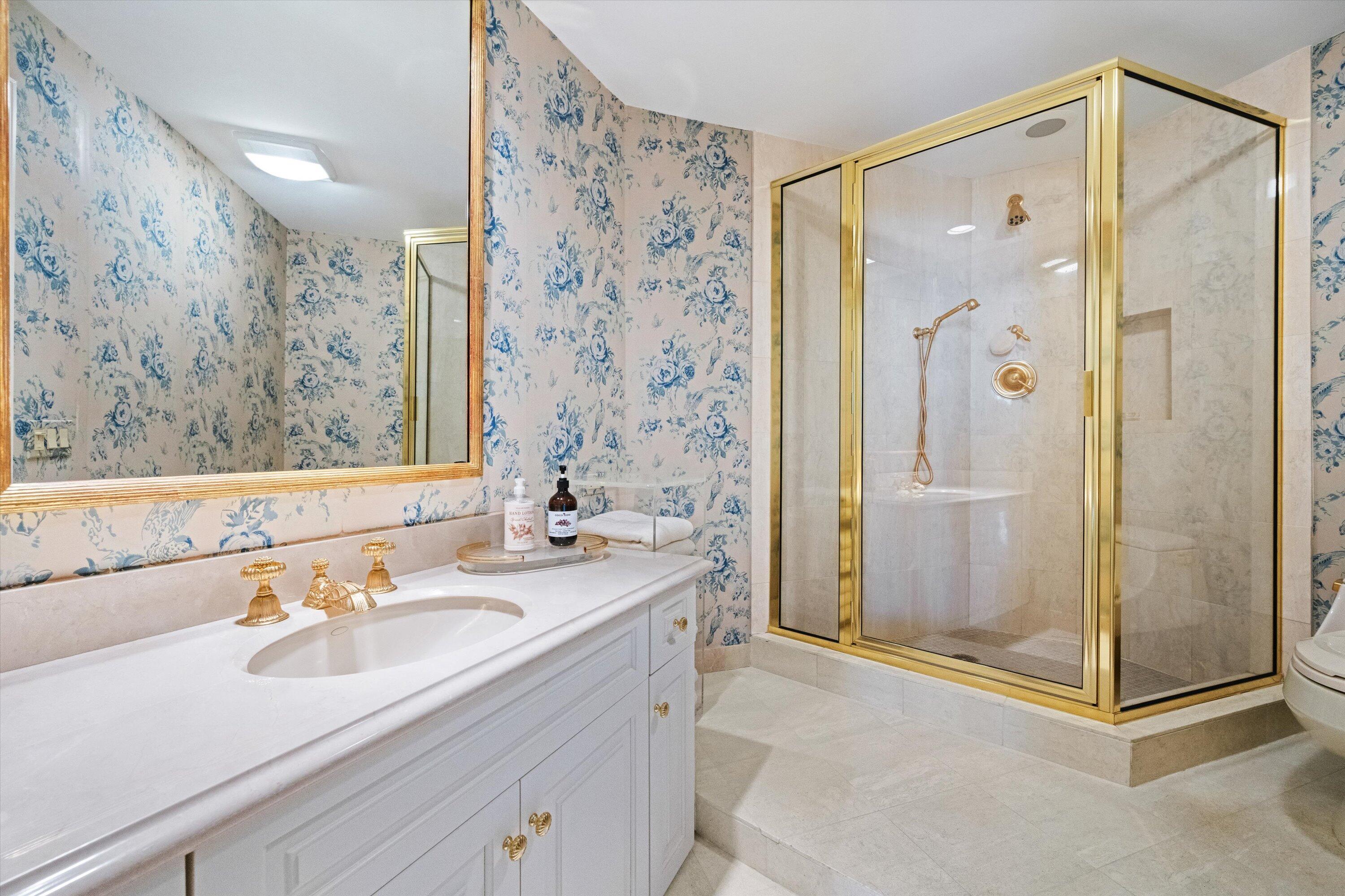 200 Bradley Place, Unit 303 Palm Beach, FL 33480 - Photo 23 of 40 a bathroom with a shower sink vanity and mirror