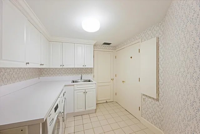a kitchen with a sink a stove and cabinets