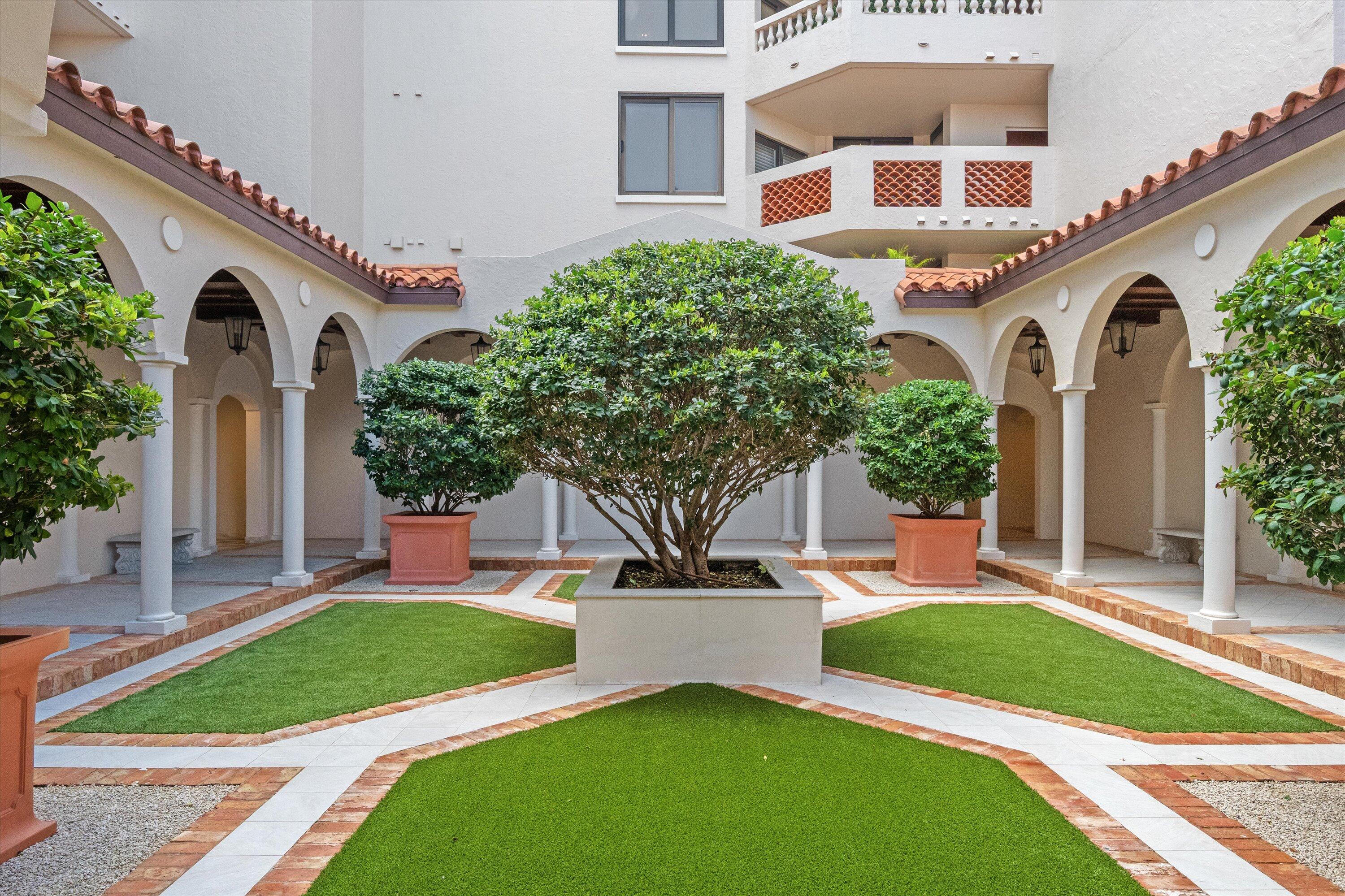 200 Bradley Place, Unit 303 Palm Beach, FL 33480 - Photo 27 of 40 a front view of a house with a yard