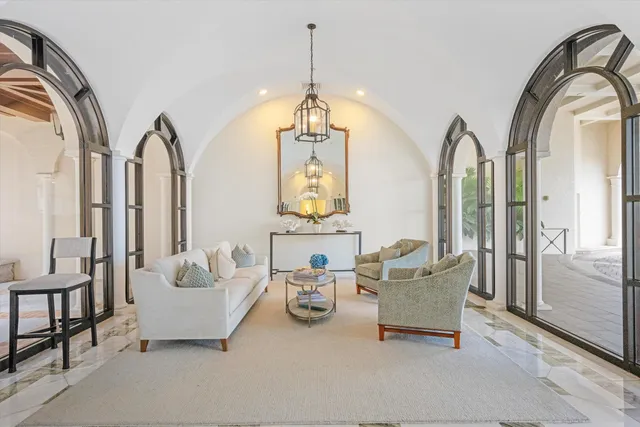 a living room with furniture and a chandelier