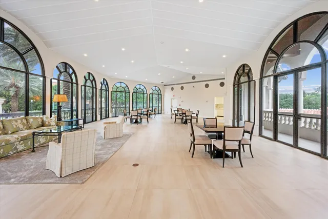 wooden floor with a large window and chairs