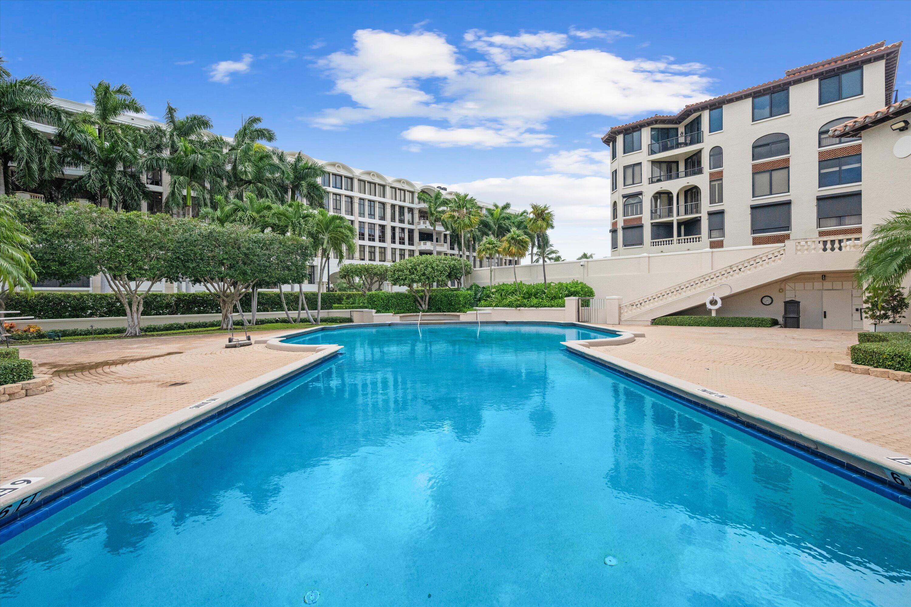200 Bradley Place, Unit 303 Palm Beach, FL 33480 - Photo 30 of 40 a view of a swimming pool with a garden and trees