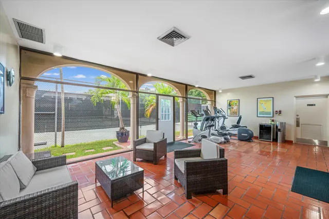 a living room with furniture and a floor to ceiling window