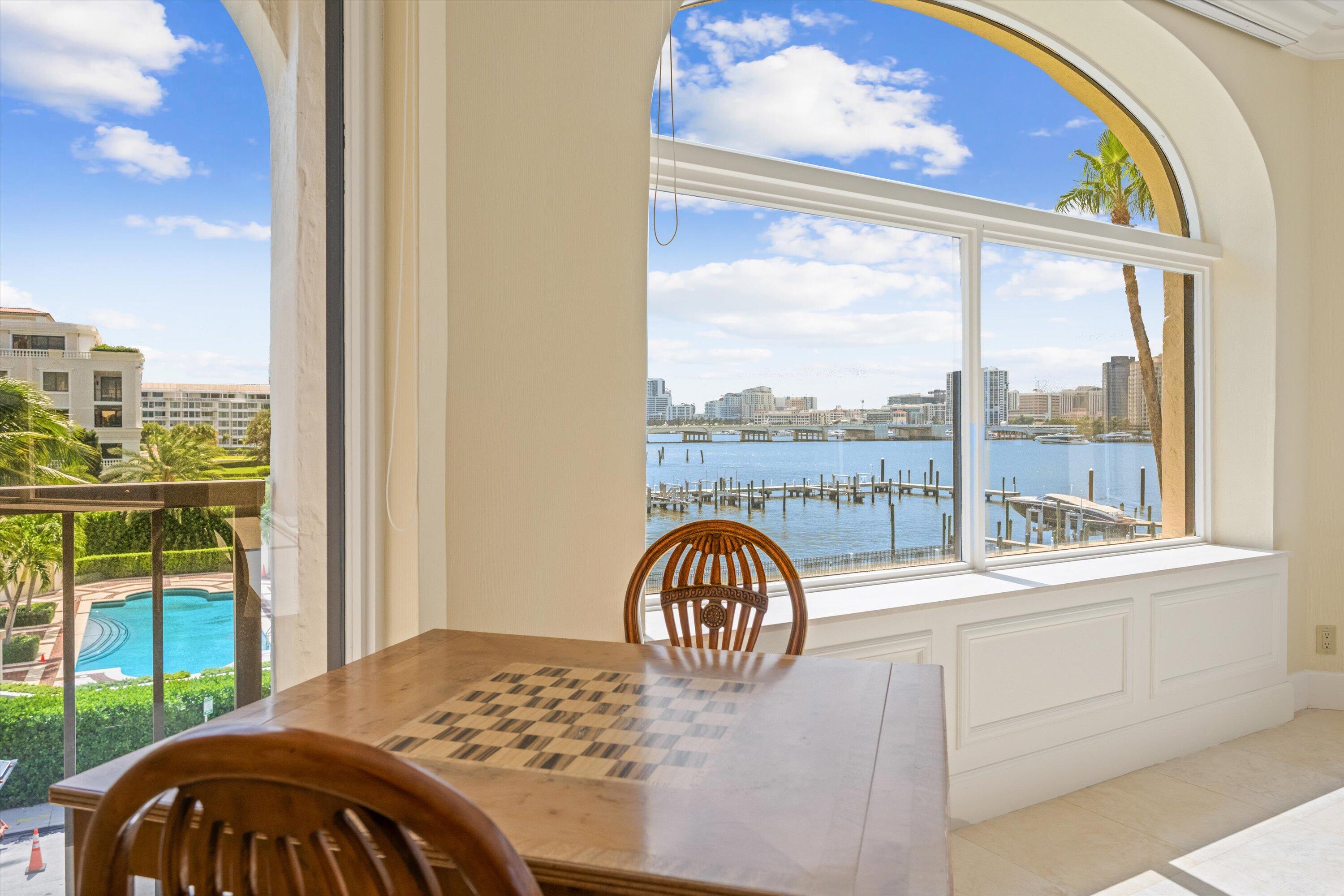 200 Bradley Place, Unit 303 Palm Beach, FL 33480 - Photo 6 of 40 a bedroom with a bed and a large window with outer view