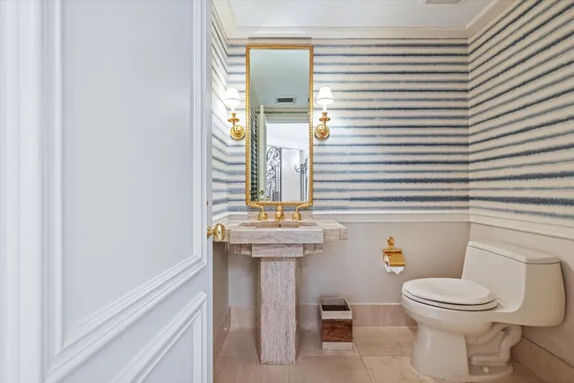 a bathroom with a toilet a sink and mirror