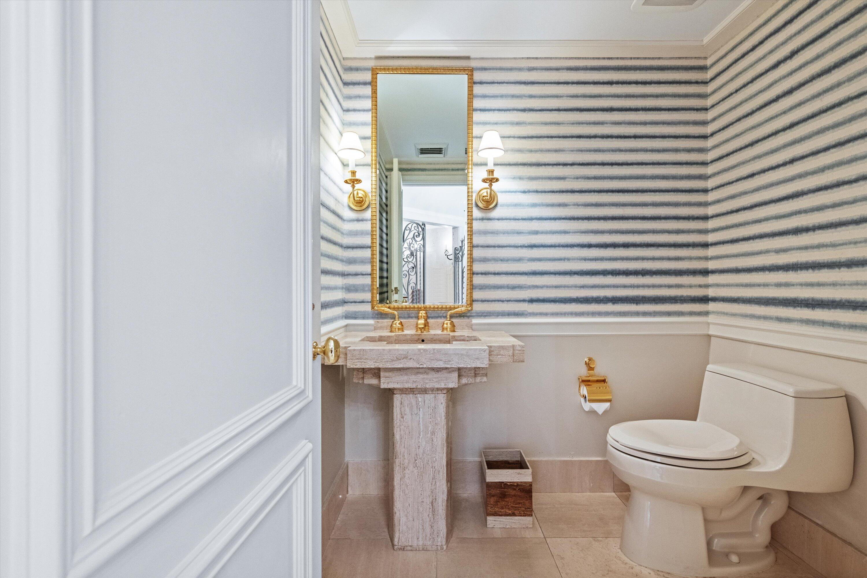 200 Bradley Place, Unit 303 Palm Beach, FL 33480 - Photo 7 of 40 a bathroom with a toilet a sink and mirror