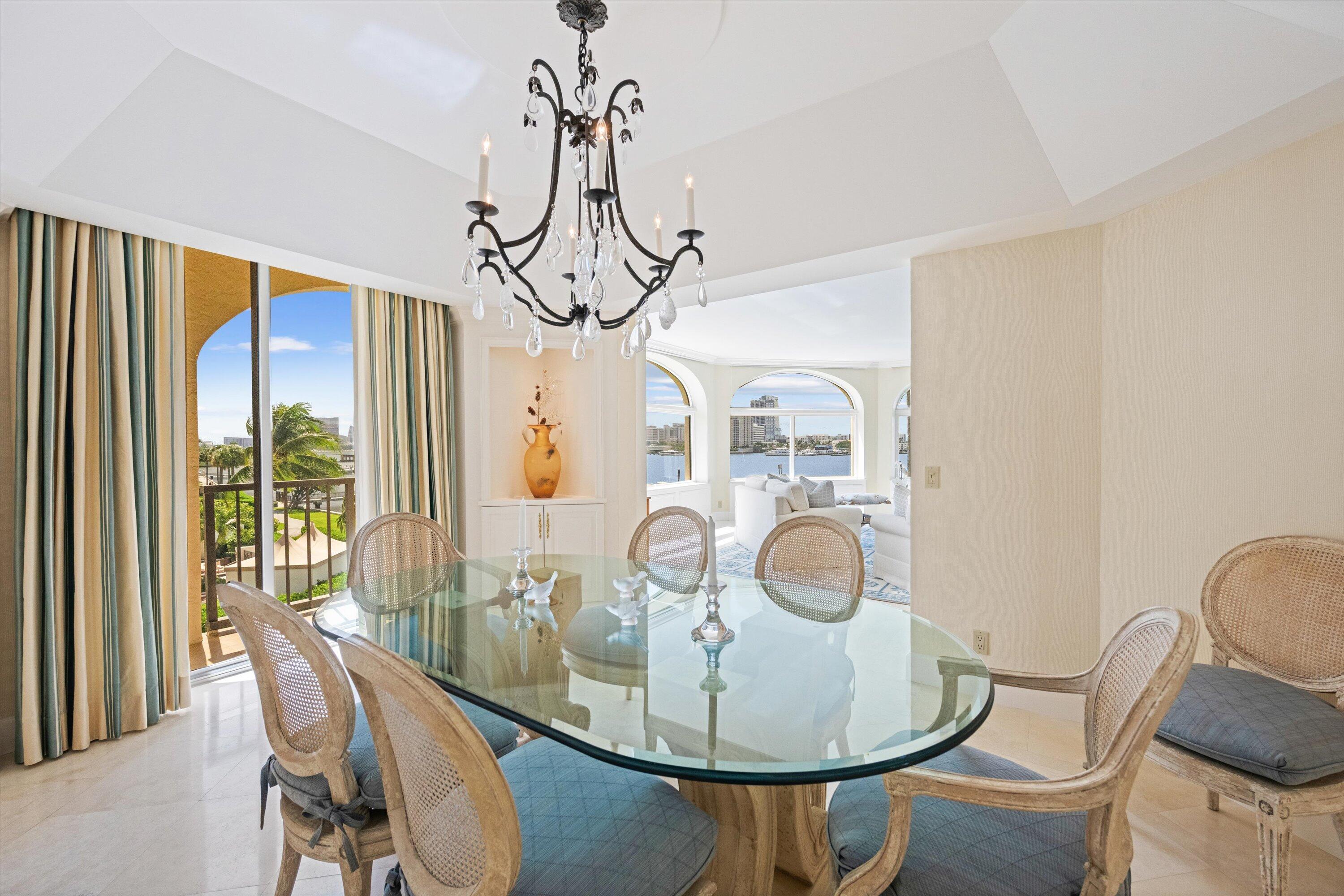 200 Bradley Place, Unit 303 Palm Beach, FL 33480 - Photo 9 of 40 a view of a dining room with furniture wooden floor and chandelier