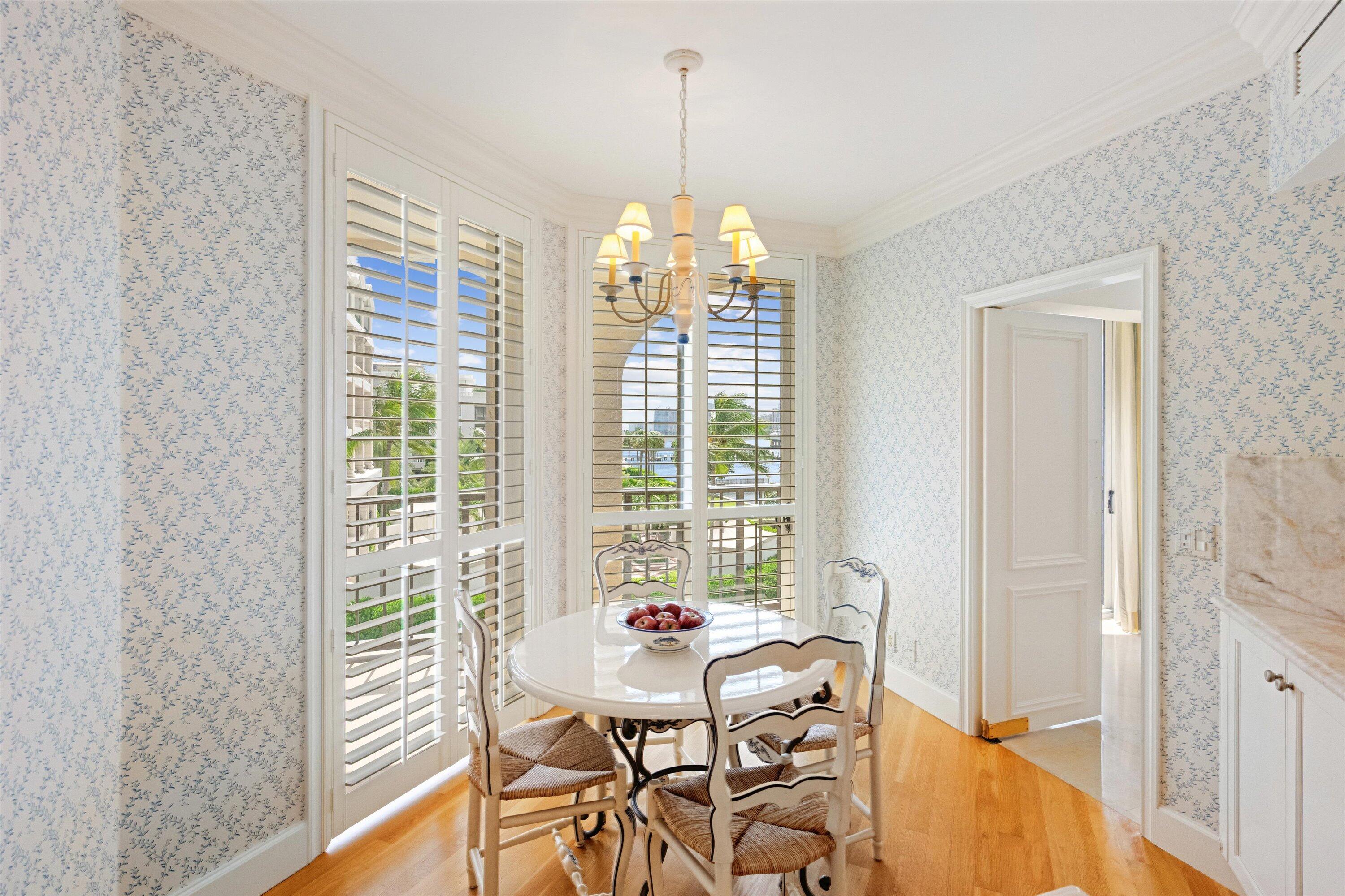 200 Bradley Place, Unit 303 Palm Beach, FL 33480 - Photo 10 of 40 a dining room with furniture a chandelier and wooden floor