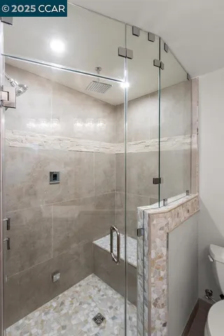 a bathroom with a shower a toilet and sink