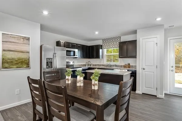 a kitchen with a table and chairs in it