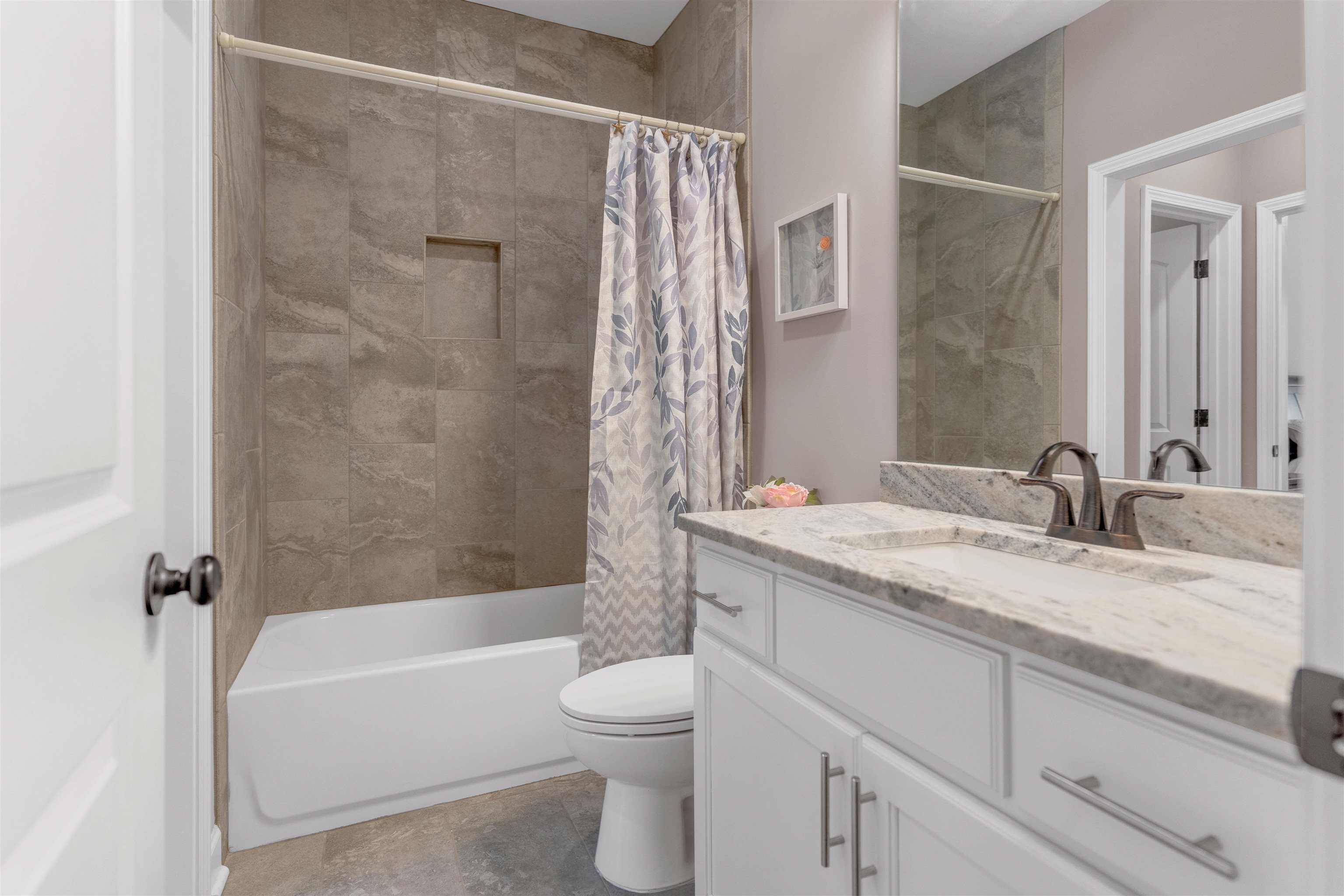 75 Windgrove Cove Piperton, TN 38017 - Photo 33 of 40 a bathroom with a granite countertop sink a toilet and shower