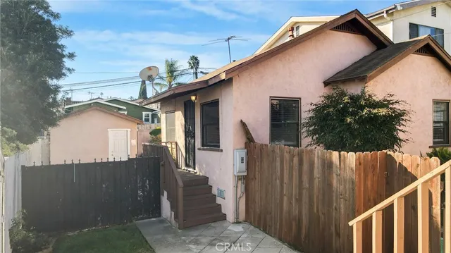 a view of a house with wooden fence