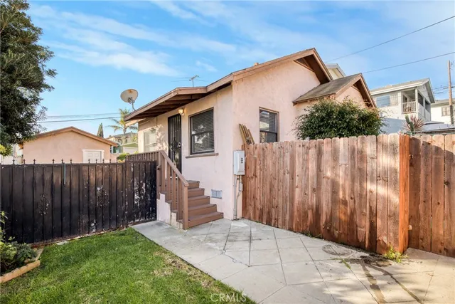 a view of a house with wooden fence