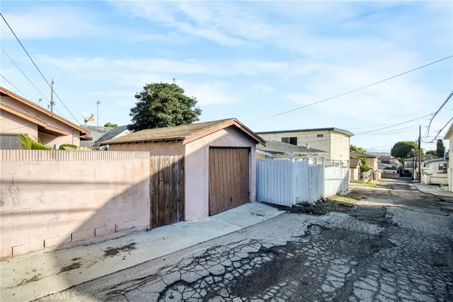 a view of a patio with table and chairs with wooden fence and plants