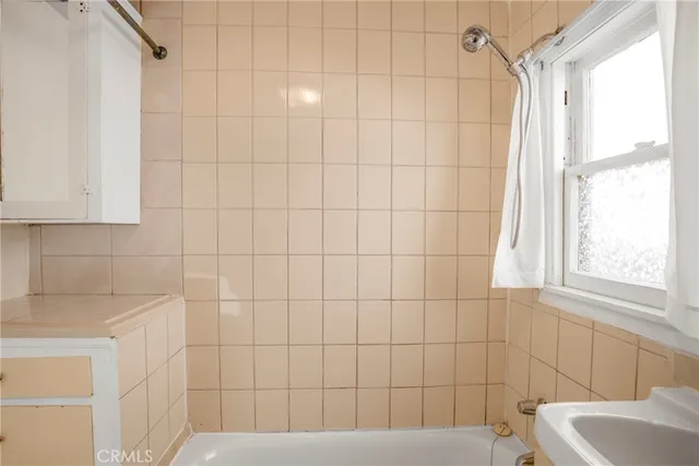 a bathroom with a bathtub and shower
